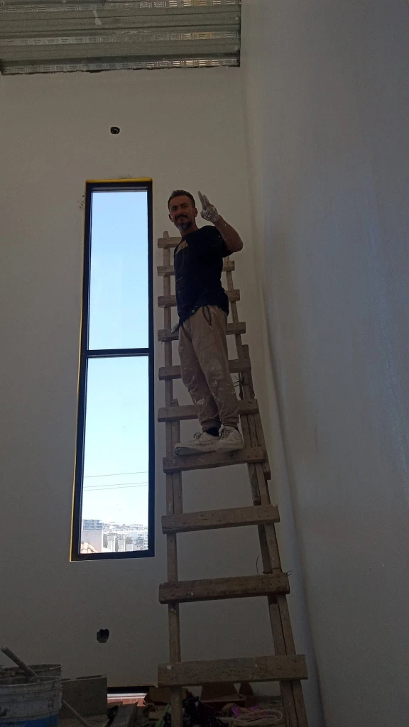 Handyman completing general home repairs inside a house