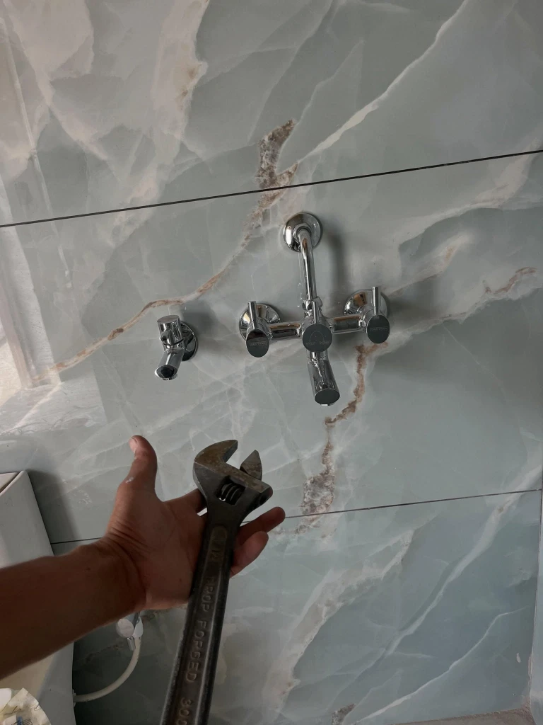 Minor plumbing repair by a handyman in a bathroom or kitchen