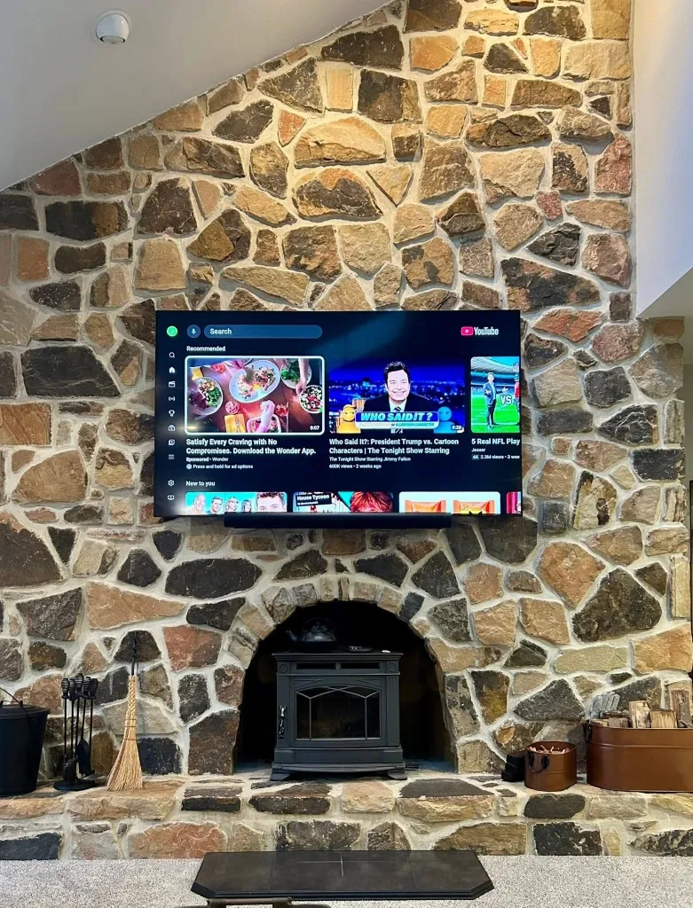 After TV fireplace mounting in Green Bay – TV mounted above a brick fireplace with hidden cables