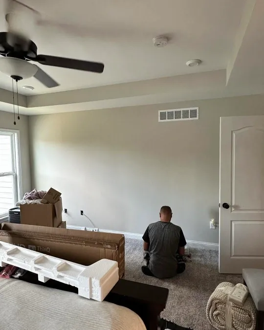 Before TV wall mounting in Green Bay – flat screen TV sitting on an entertainment stand