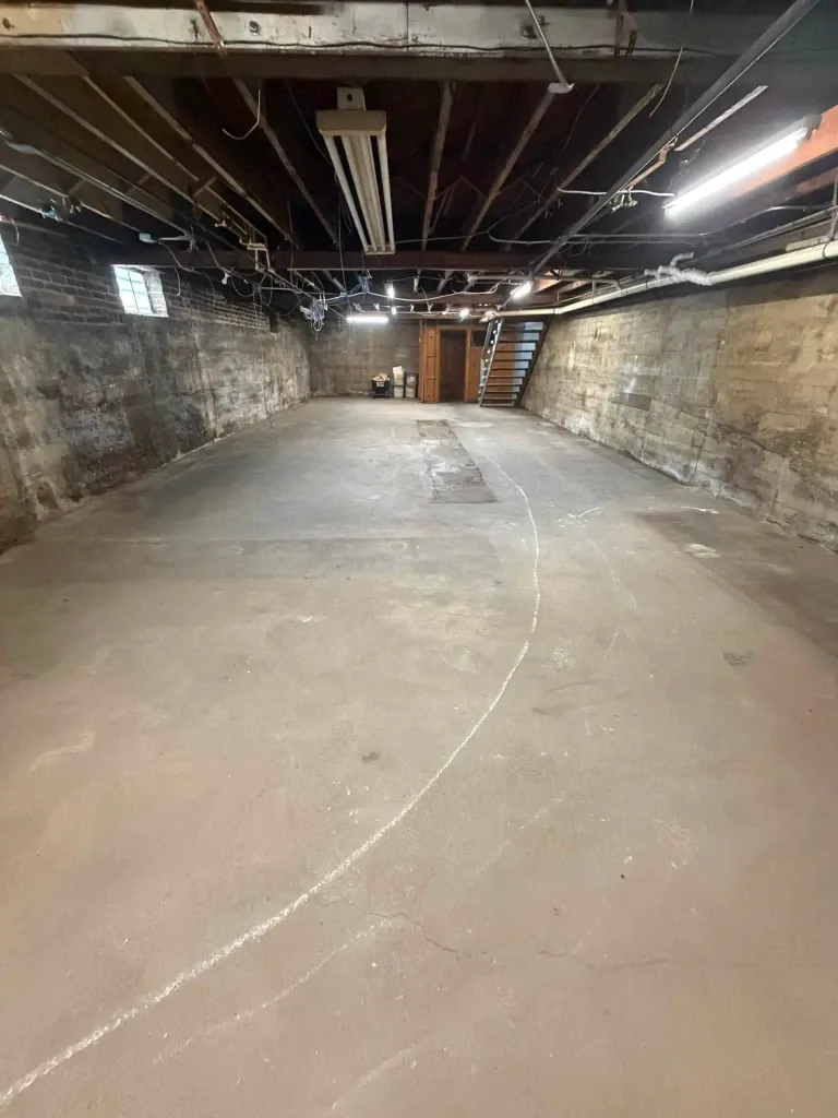 After basement junk removal in Green Bay – clean, open basement ready for use