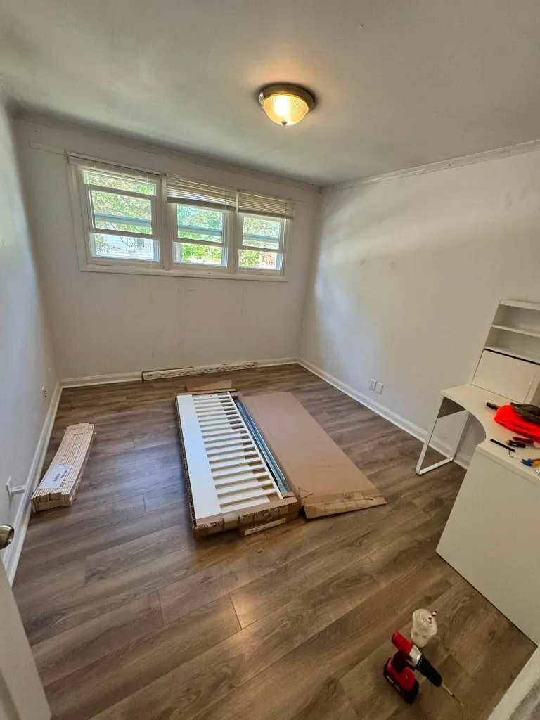Before bed assembly in Green Bay – unassembled bed frame parts on bedroom floor