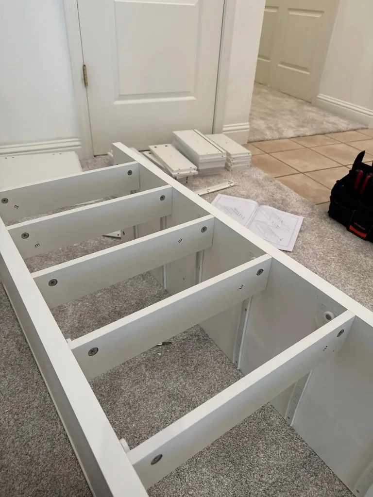 Before drawer assembly in Green Bay – boxed office drawer parts laid out on the floor