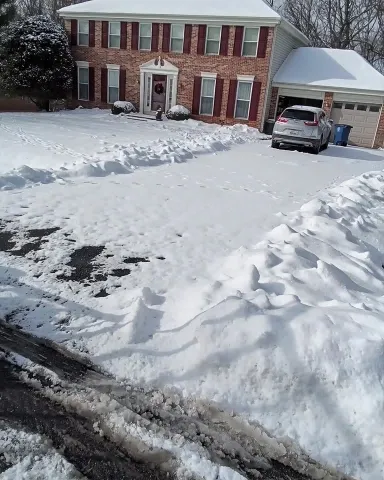 Before driveway snow removal in Green Bay – heavy wet snow covering a residential driveway
