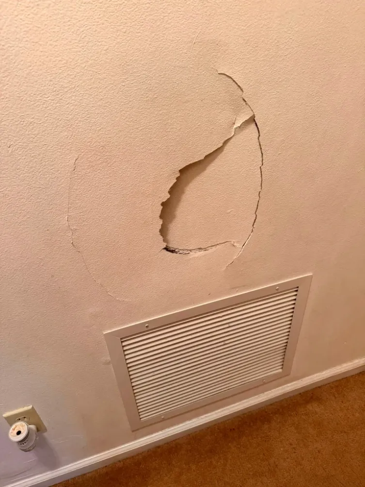 Before drywall crack repair in Green Bay – diagonal stress crack above doorway