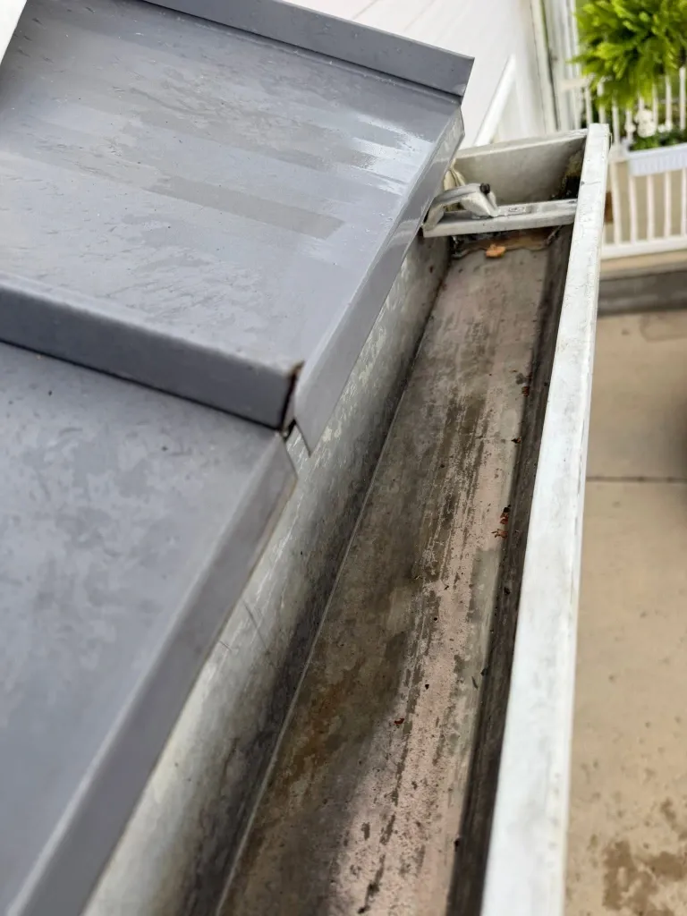 After gutter downspout cleaning in Green Bay – clear downspout draining water away from the foundation