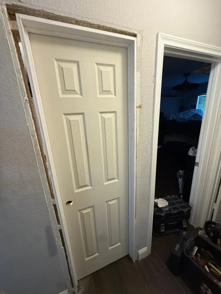 Before interior door repair in Green Bay – sagging interior door rubbing against the floor
