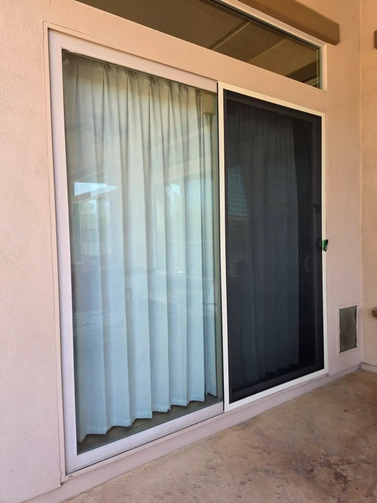 After sliding screen door repair in Green Bay – new, secure mesh on a sliding patio screen door