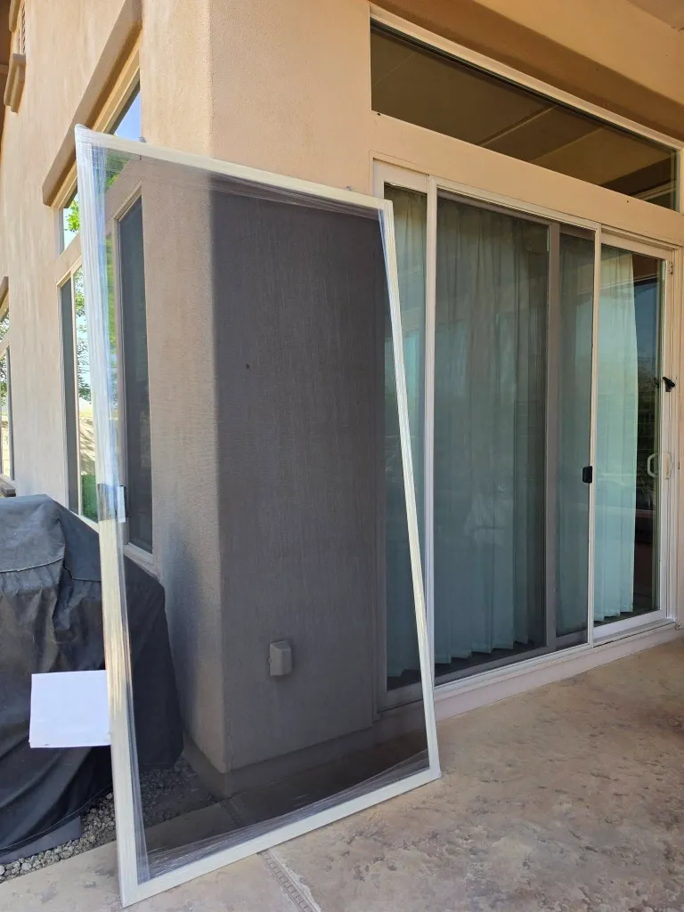 Before sliding screen door repair in Green Bay – ripped mesh on a sliding patio screen door