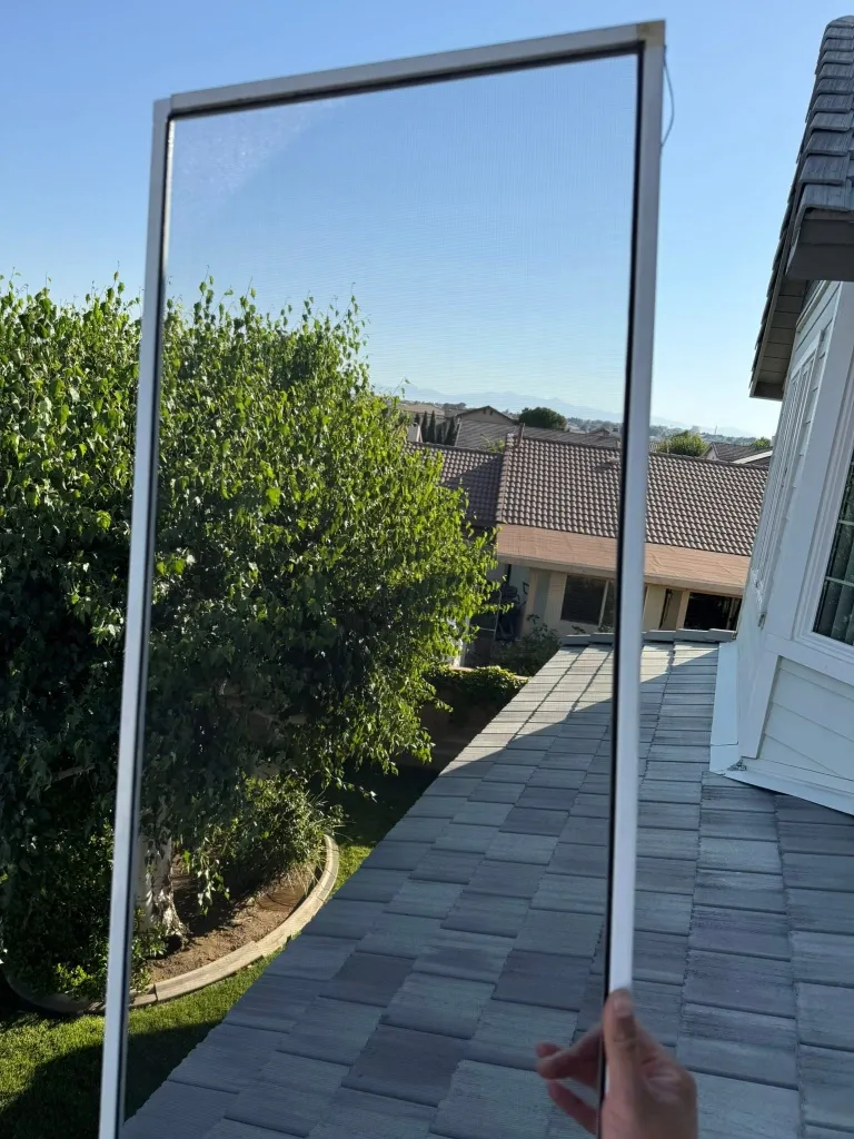 After window screen repair in Green Bay – tight, new mesh on a residential window screen