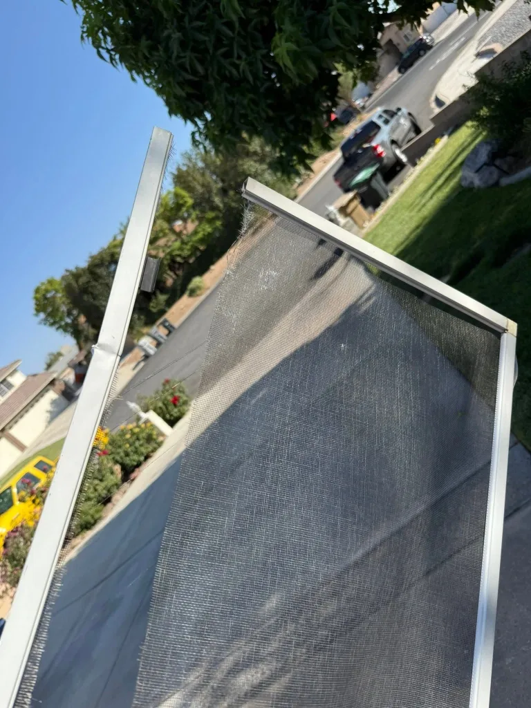 Before window screen repair in Green Bay – torn mesh on a residential window screen